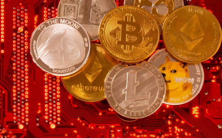 Representations of cryptocurrencies Bitcoin, Ethereum, DogeCoin, Ripple, Litecoin are placed on PC motherboard in this illustration taken, June 29, 2021. REUTERS/Dado Ruvic